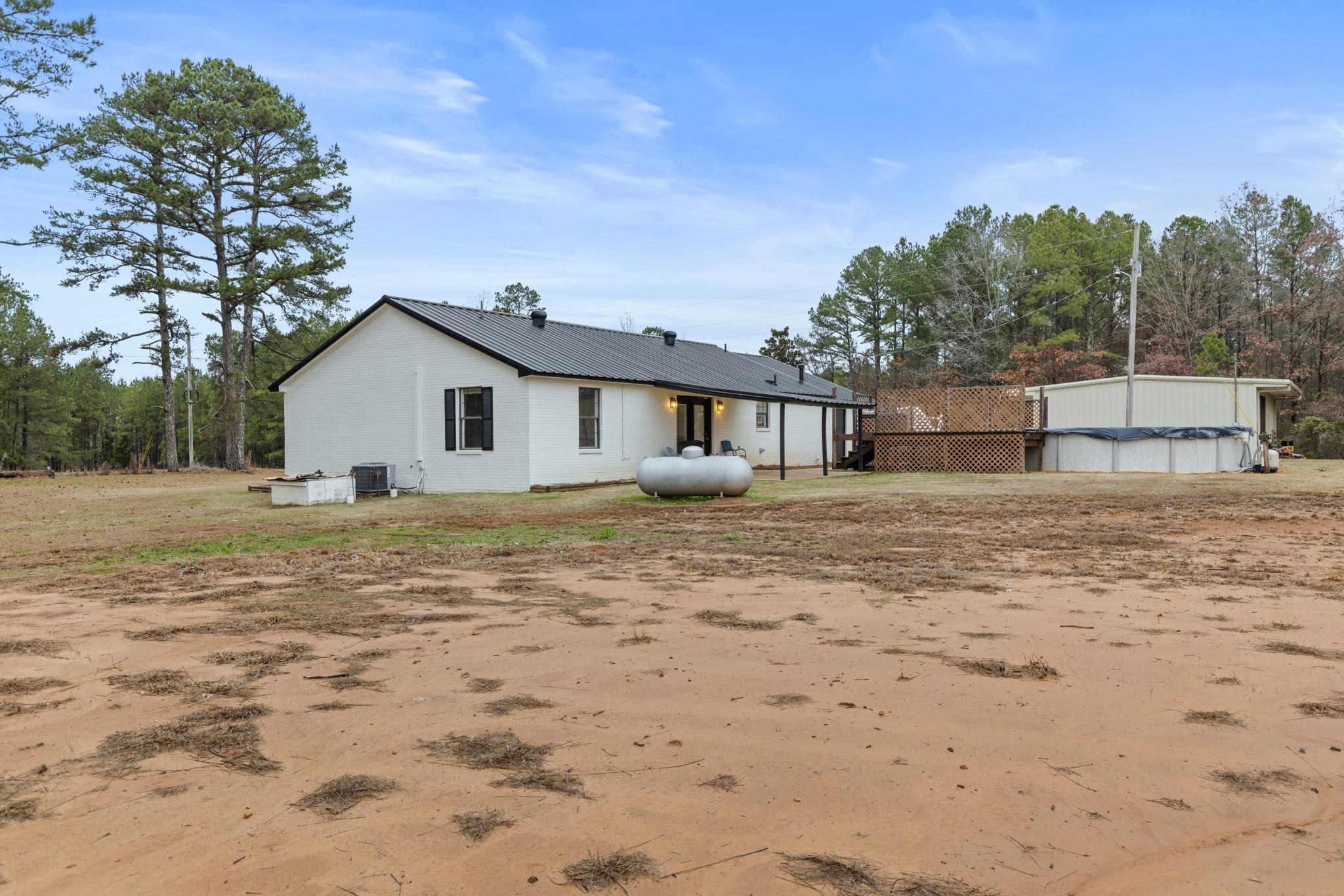 310 County Road 638 Corinth, MS 38834 - Photo 5 of 40 Rear view of property with a metal roof and a covered pool