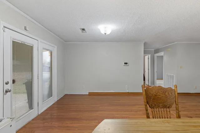 a room with a bed and glass door