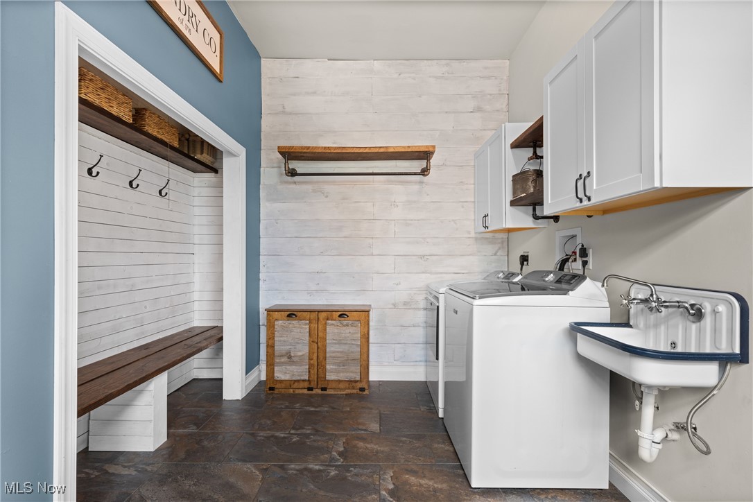 56380 Hospital Road Bellaire, OH 43906 - Photo 23 of 45 Laundry room with independent washer and dryer, cabinet space, wooden walls, and dark stone finish floors