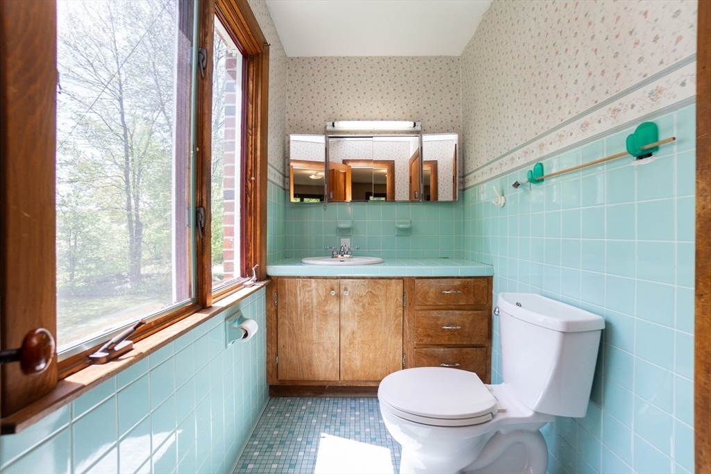 152 Stowell Road Ashburnham, MA 01430 - Photo 11 of 38 a bathroom with a toilet a sink and a mirror