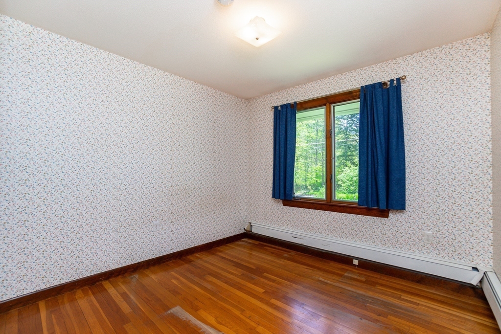 152 Stowell Road Ashburnham, MA 01430 - Photo 13 of 38 a view of an empty room with wooden floor and a window