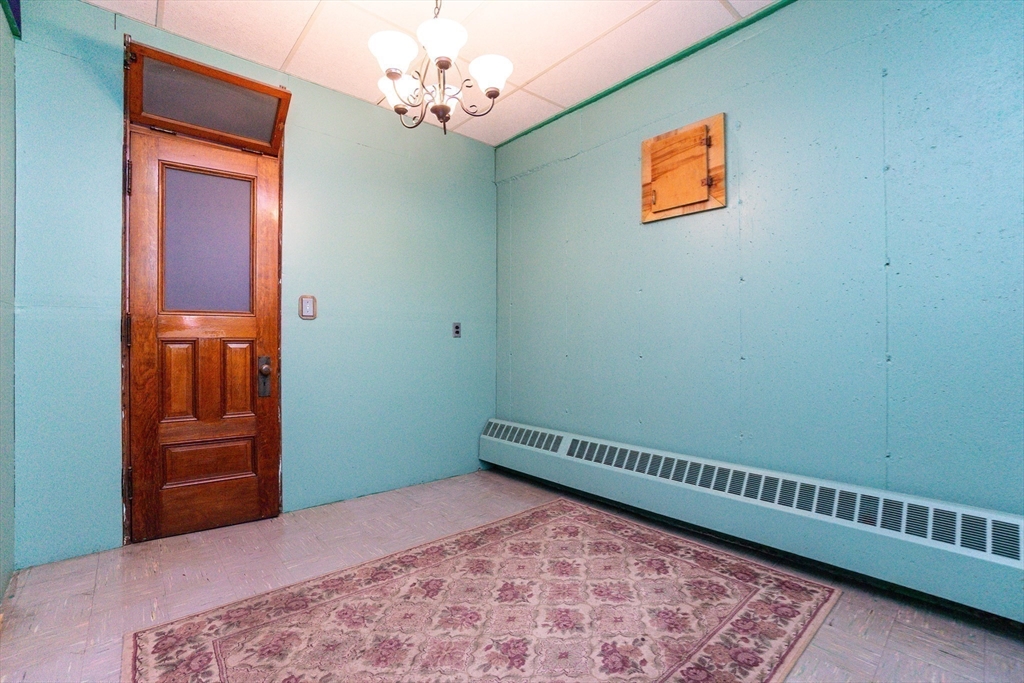 152 Stowell Road Ashburnham, MA 01430 - Photo 19 of 38 a view of a hallway with a chandelier