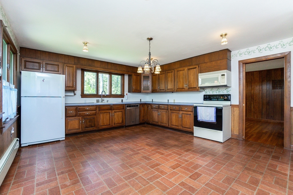 152 Stowell Road Ashburnham, MA 01430 - Photo 6 of 38 a kitchen with stainless steel appliances granite countertop a refrigerator and a sink