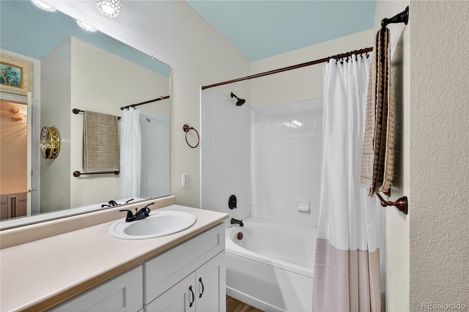 18611 Stroh Road, Unit 5203 Parker, CO 80134 - Photo 15 of 28 a bathroom with a double vanity sink and mirror with shower