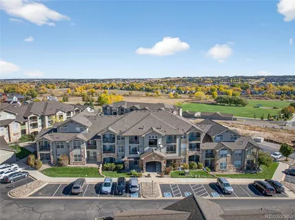 an aerial view of a house with a yard and a fountain
