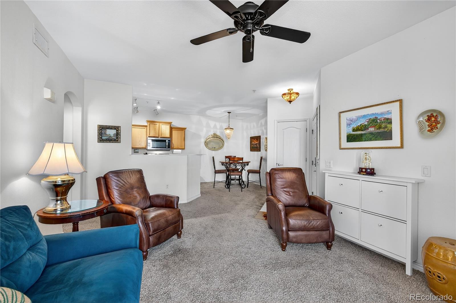 18611 Stroh Road, Unit 5203 Parker, CO 80134 - Photo 3 of 28 a living room with furniture and a flat screen tv