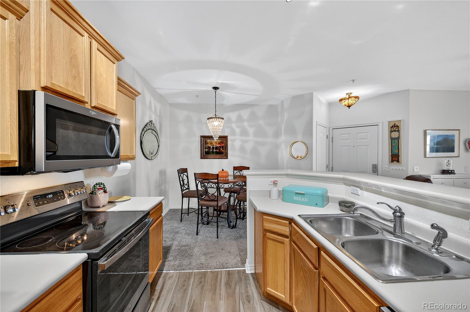 18611 Stroh Road, Unit 5203 Parker, CO 80134 - Photo 7 of 28 a kitchen with a sink appliances and cabinets