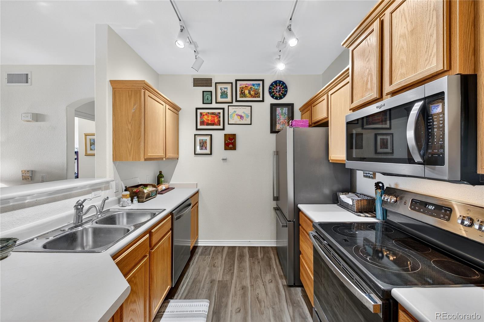 18611 Stroh Road, Unit 5203 Parker, CO 80134 - Photo 8 of 28 a kitchen with stainless steel appliances a stove a sink dishwasher a refrigerator and a stove