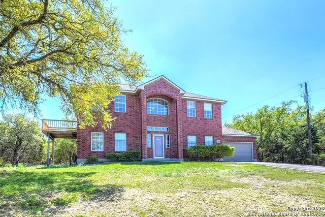 a view of a brick house with a yard