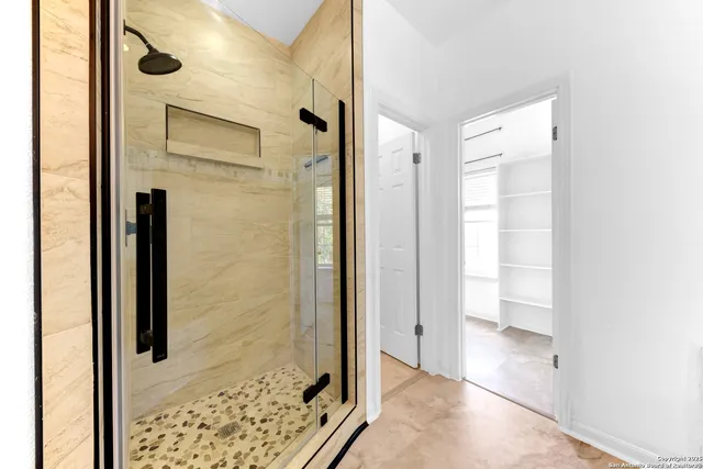 a bathroom with a shower and a sink