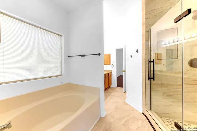 a bathroom with a tub and shower