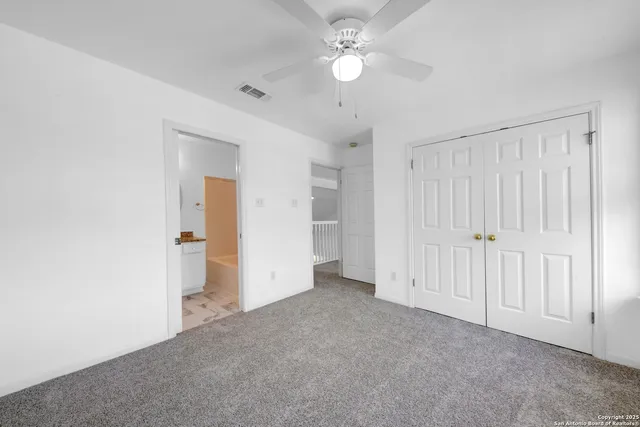 an empty room with a ceiling fan and hardwood floor