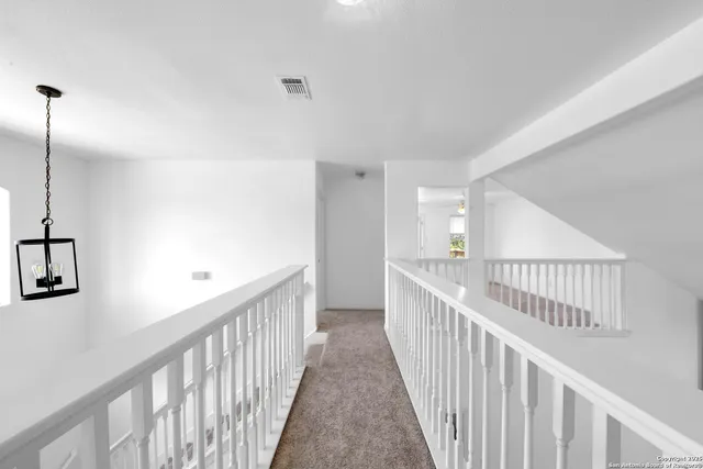 a view of a hallway with windows