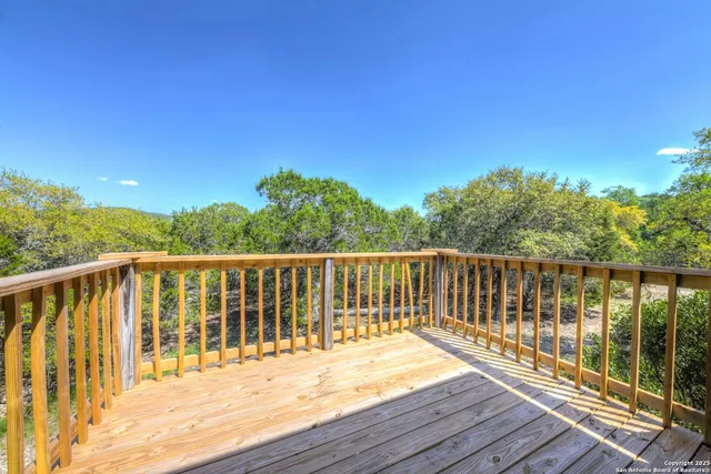 a view of balcony with wooden floor and fence