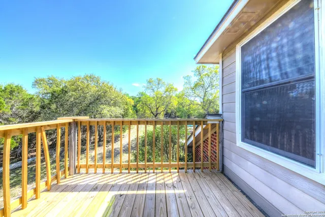 a view of balcony with wooden floor