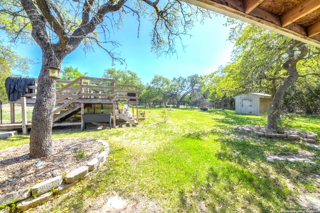a view of a house with backyard and sitting area