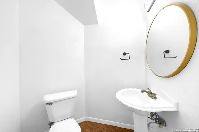 a bathroom with a sink a mirror and a toilet