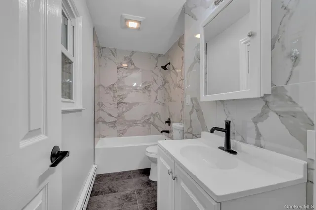 a bathroom with a sink a toilet and a bathtub
