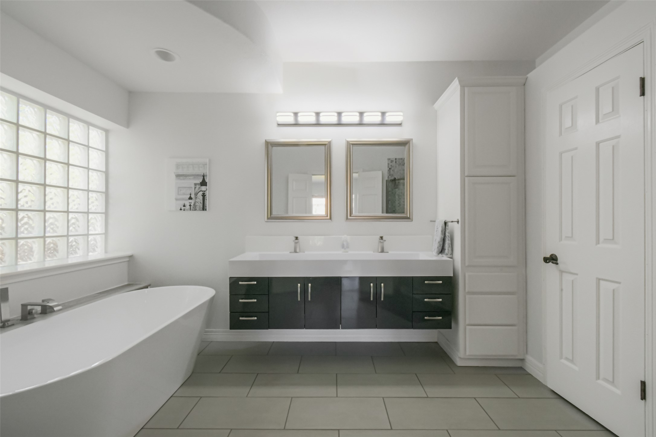 8903 Halder Cove Austin, TX 78717 - Photo 11 of 26 Full bath with double vanity, a freestanding tub, and light tile patterned flooring