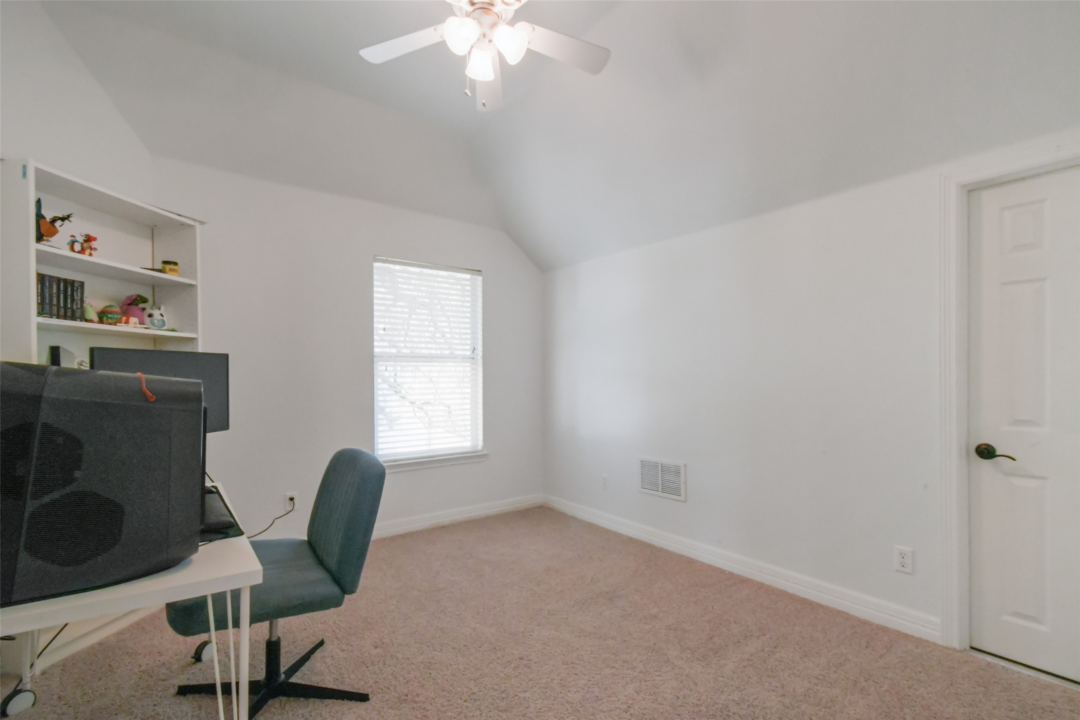 8903 Halder Cove Austin, TX 78717 - Photo 12 of 26 Bedroom 1 space with ceiling fan, light carpet, and vaulted ceiling