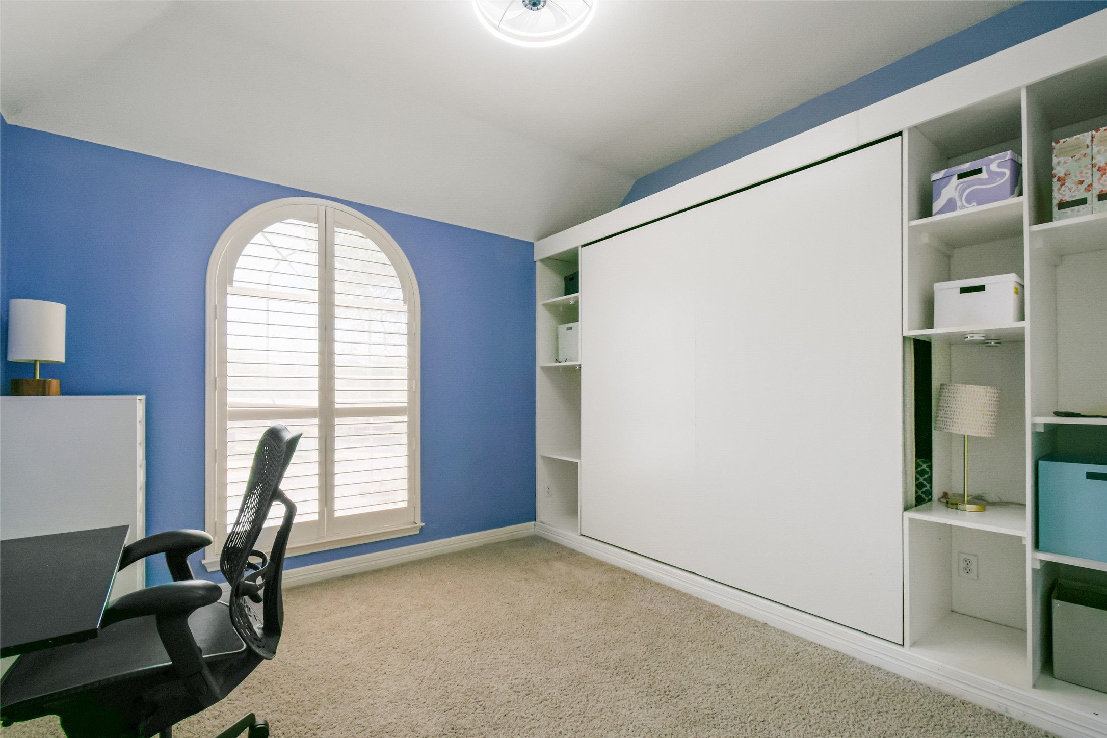 8903 Halder Cove Austin, TX 78717 - Photo 14 of 26 Bedroom 2 featuring light carpet, lofted ceiling, and built in shelves, and Murphy Bed