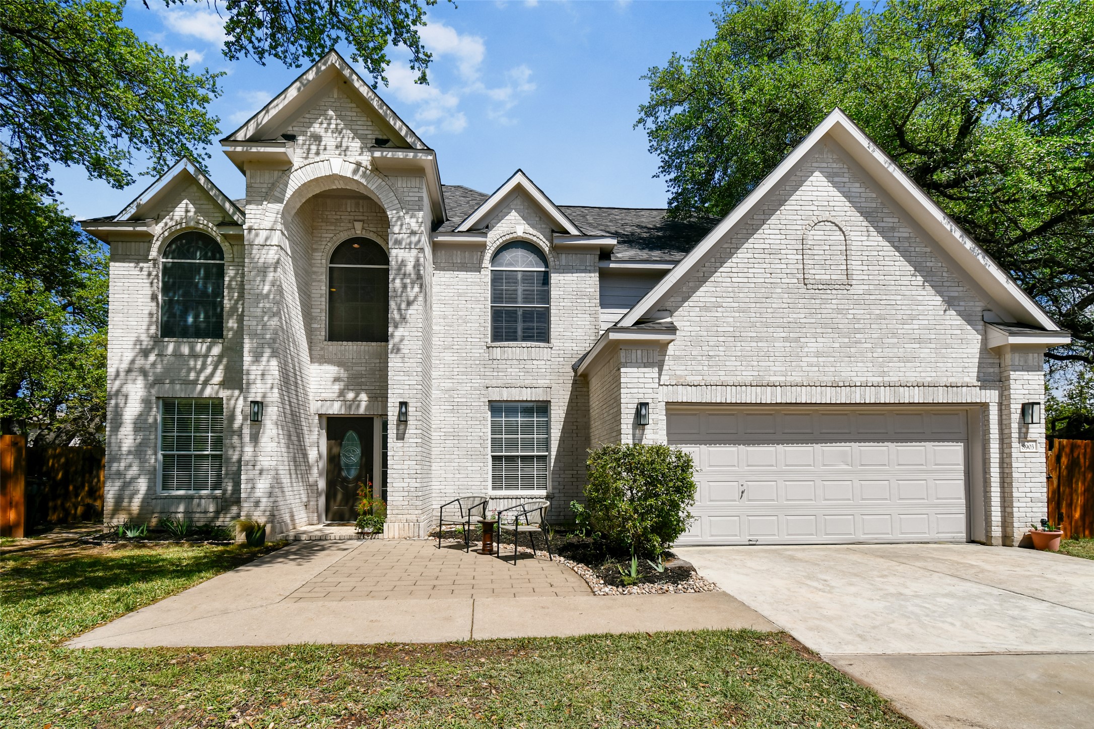 8903 Halder Cove Austin, TX 78717 - Photo 2 of 26 View of front of property featuring driveway, brick siding, and a garage