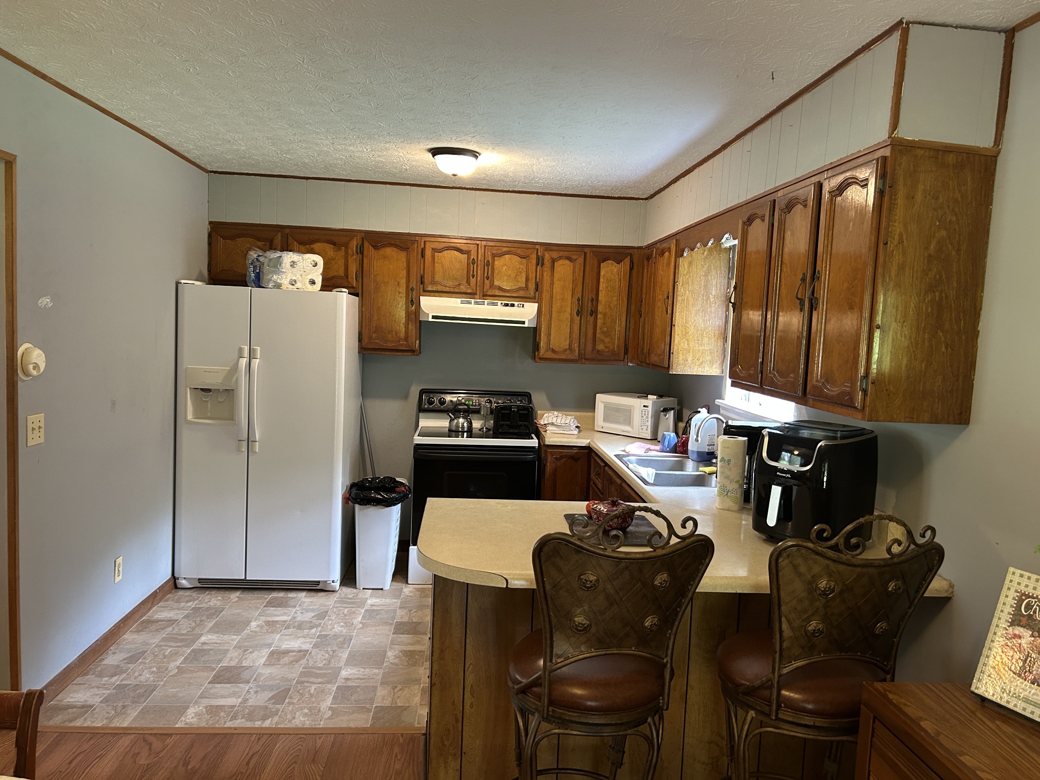 1041 Roysden Road Jamestown, TN 38556 - Photo 13 of 18 a kitchen with a refrigerator and a stove top oven