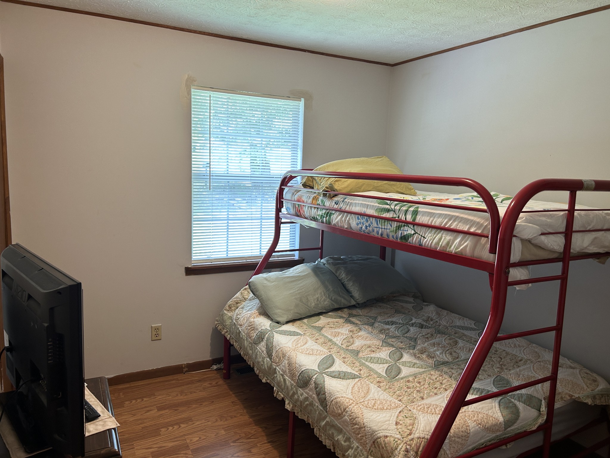 1041 Roysden Road Jamestown, TN 38556 - Photo 17 of 18 a bedroom with a bed and wooden floor