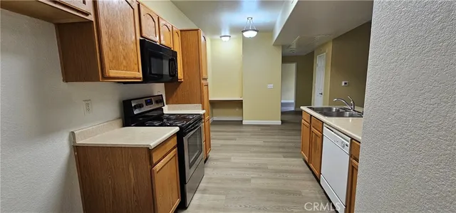 a kitchen with a sink stove top oven and cabinets
