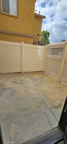 an empty room with wooden floor and windows in it