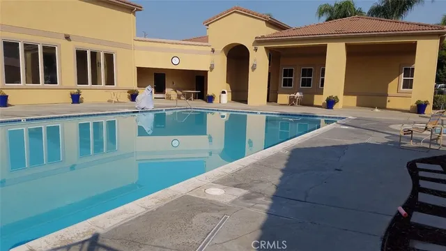 a view of a house with a yard and sitting area