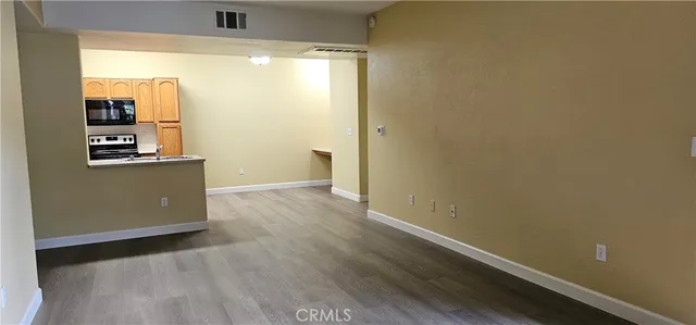 a view of a room with wooden floor and wardrobe