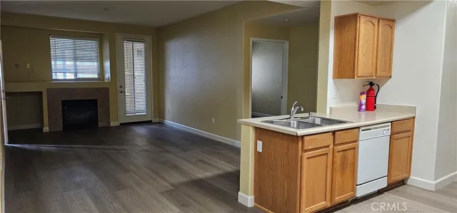 a kitchen with granite countertop a sink and a stove top oven