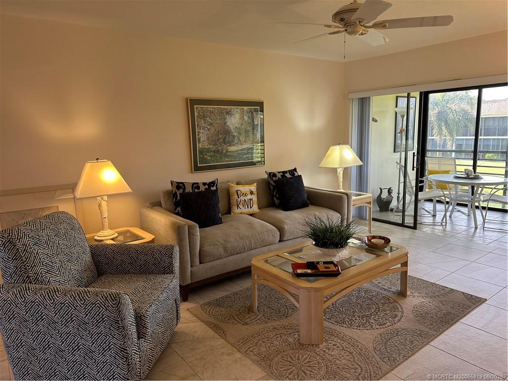 755 Saturn Street, Unit F205 Jupiter, FL 33477 - Photo 5 of 19 a living room with furniture and a large window