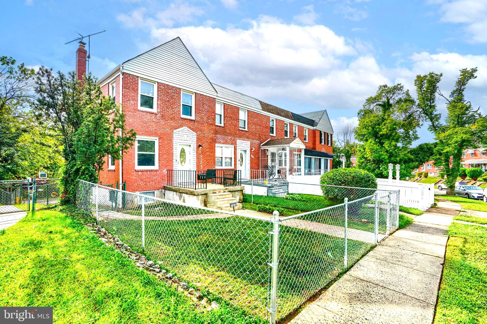 755 South Woodington Road Baltimore, MD 21229 - Photo 1 of 40 a front view of a house with a yard table and chairs