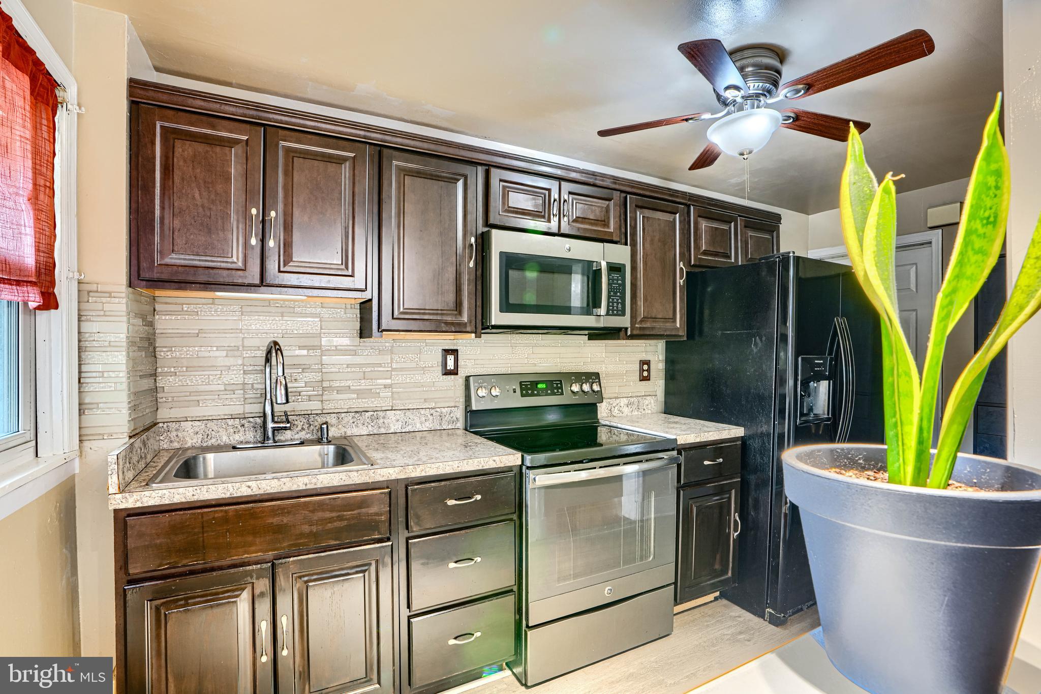 755 South Woodington Road Baltimore, MD 21229 - Photo 12 of 40 a kitchen with a sink and a stove top oven