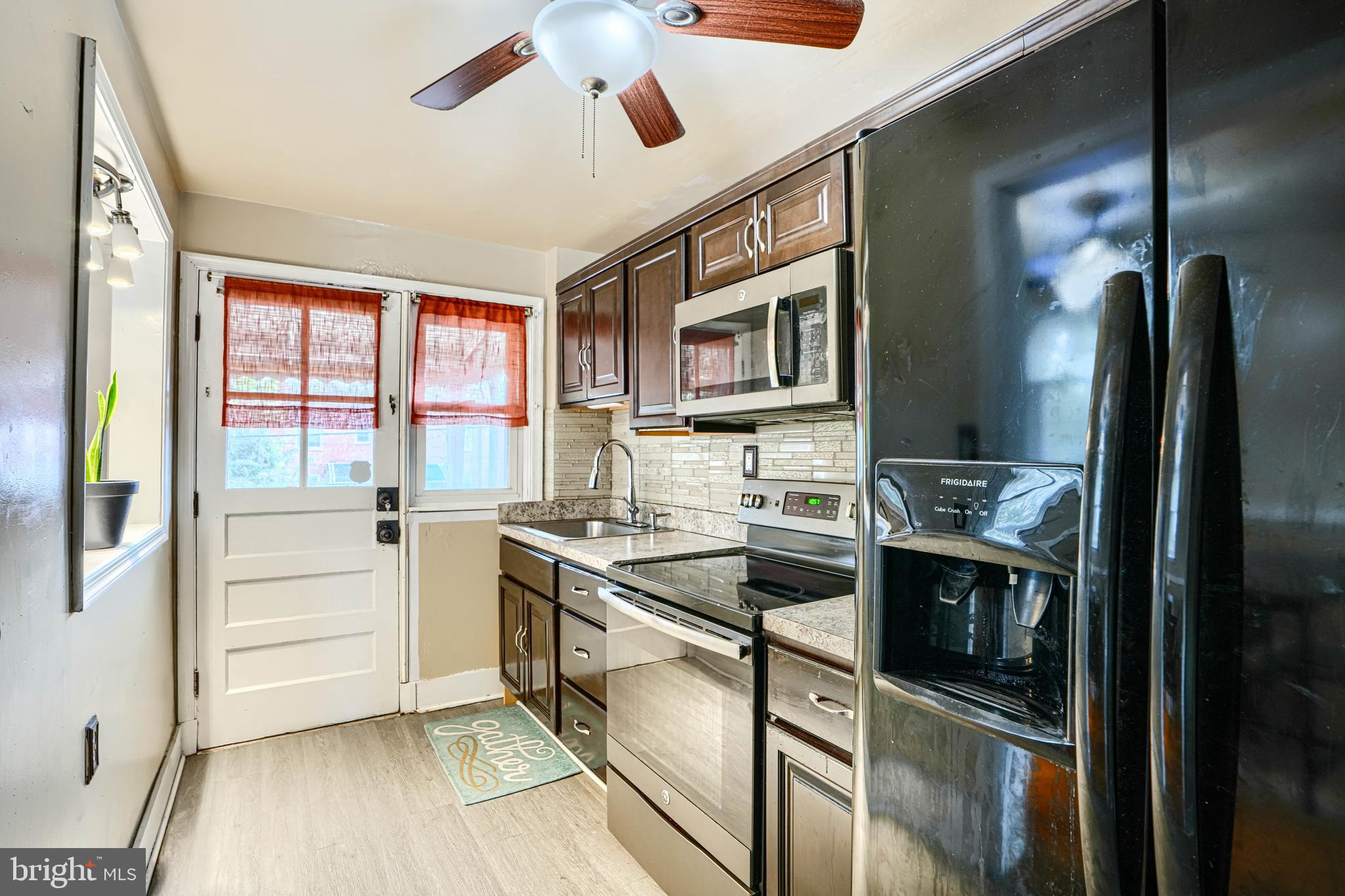 755 South Woodington Road Baltimore, MD 21229 - Photo 14 of 40 a kitchen with stainless steel appliances granite countertop a sink and a stove top oven