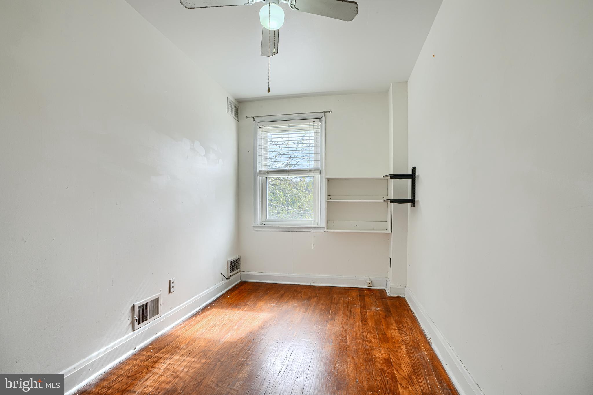 755 South Woodington Road Baltimore, MD 21229 - Photo 19 of 40 wooden floor in an empty room with a window