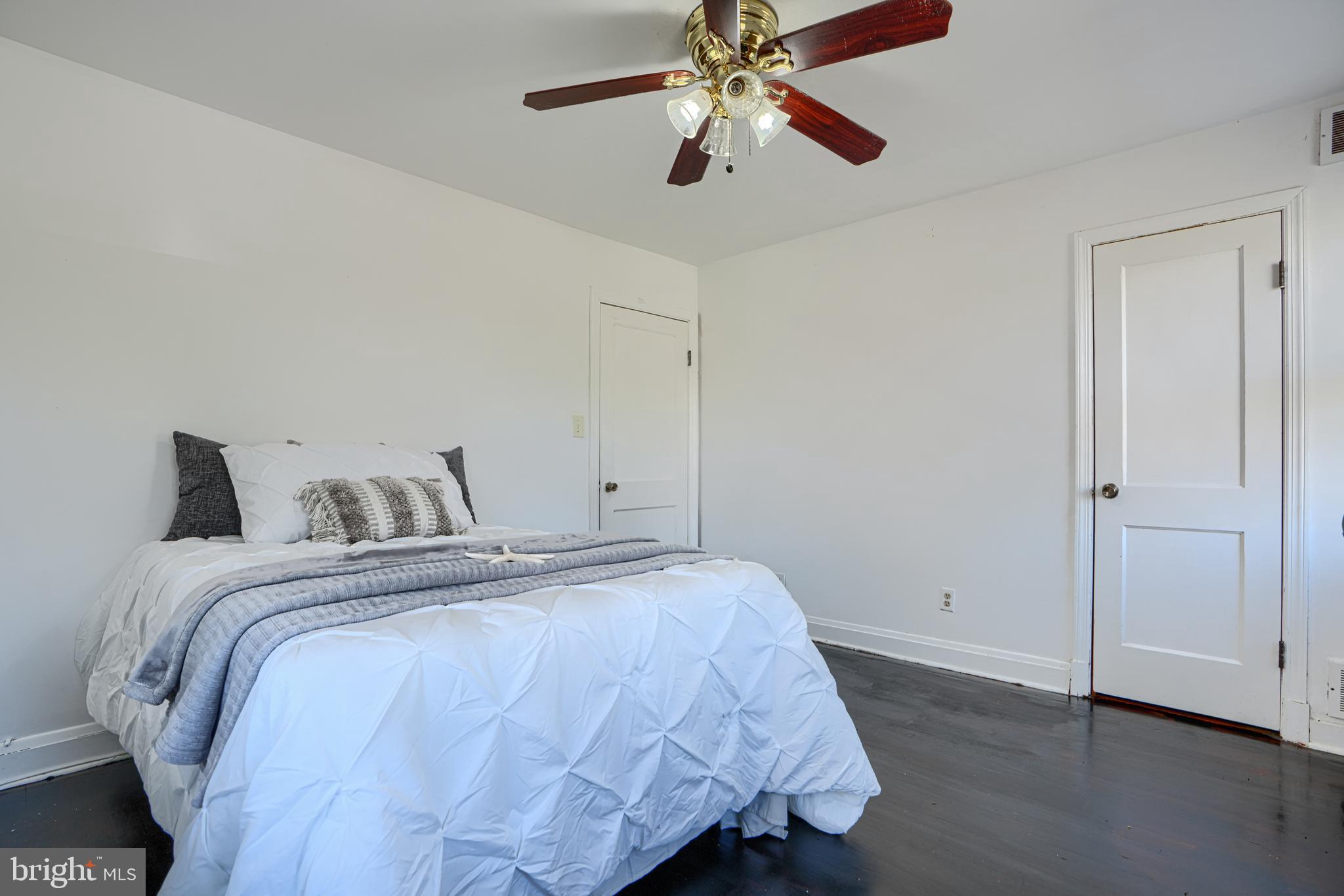 755 South Woodington Road Baltimore, MD 21229 - Photo 24 of 40 a bedroom with a bed and a chandelier