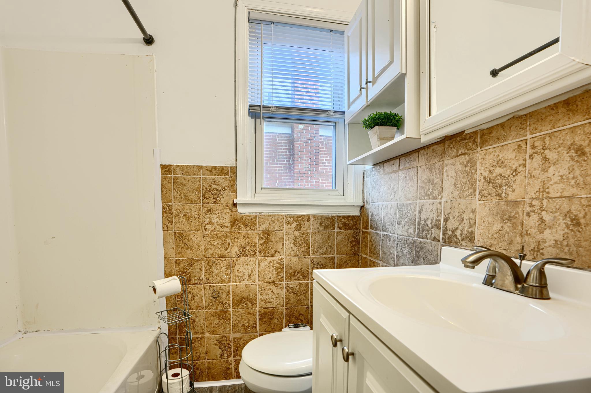 755 South Woodington Road Baltimore, MD 21229 - Photo 25 of 40 a bathroom with a sink a toilet and mirror
