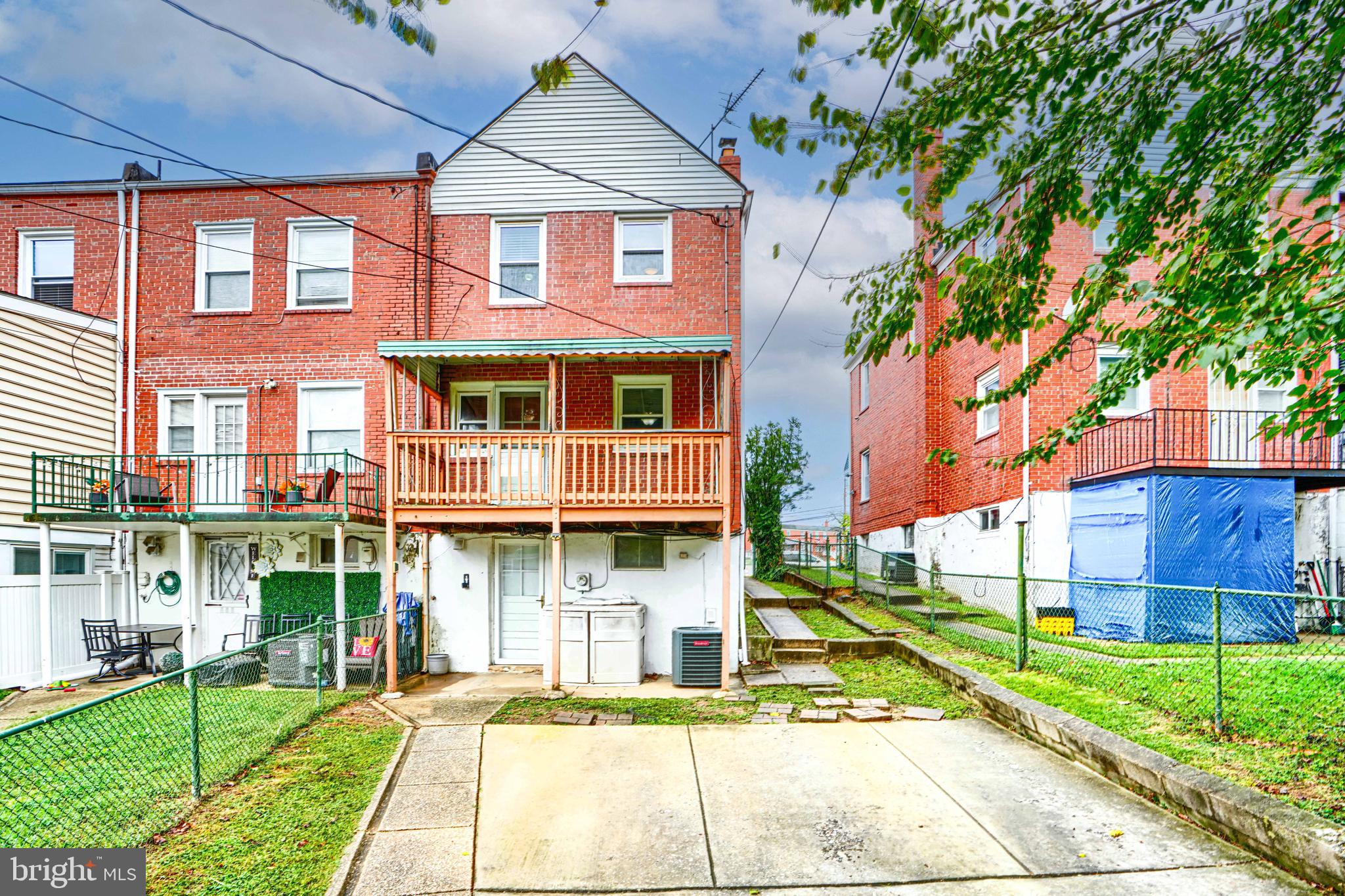 755 South Woodington Road Baltimore, MD 21229 - Photo 36 of 40 a front view of a residential apartment building with a yard