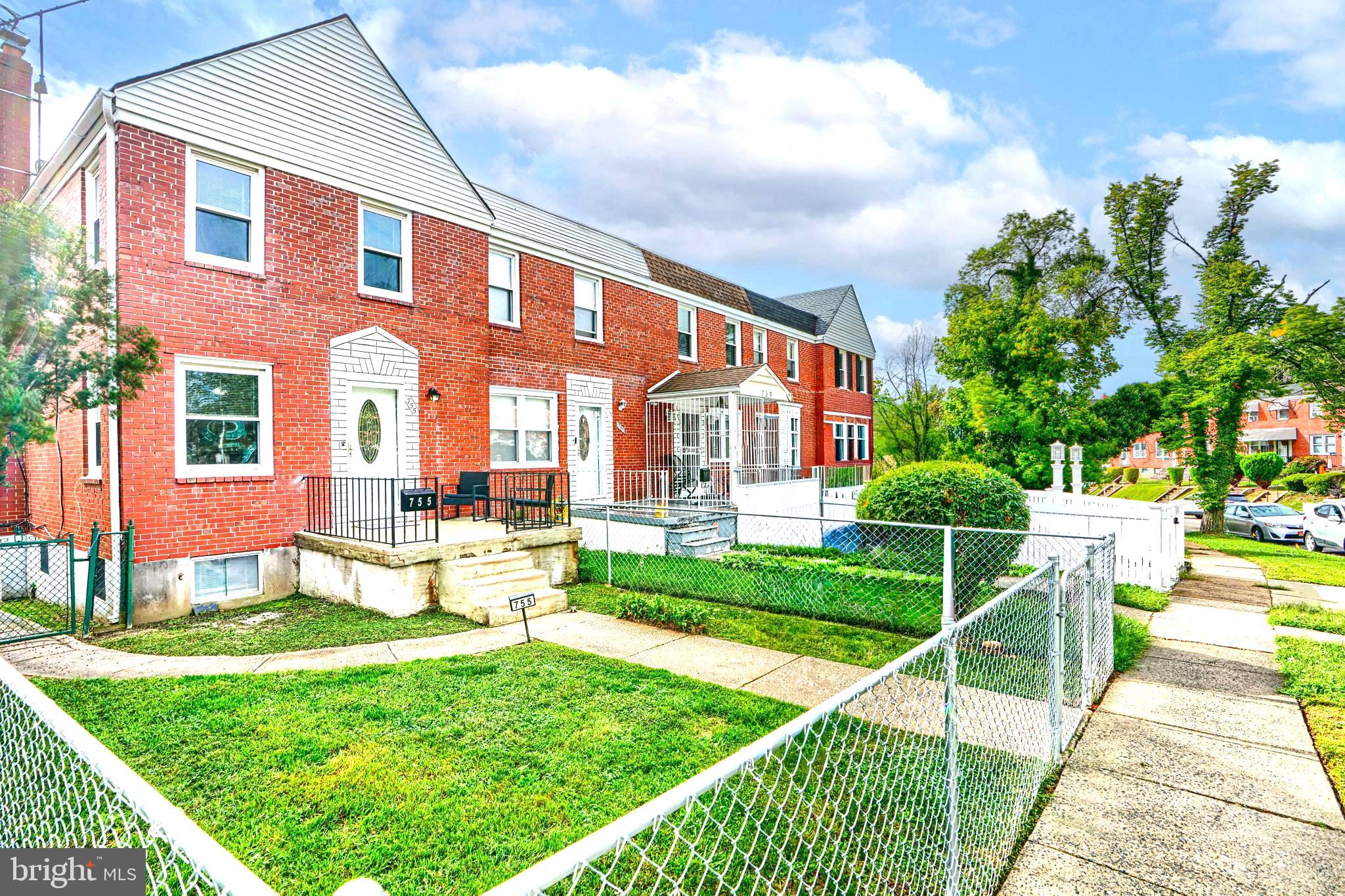 755 South Woodington Road Baltimore, MD 21229 - Photo 4 of 40 a front view of a house with a yard table and chairs