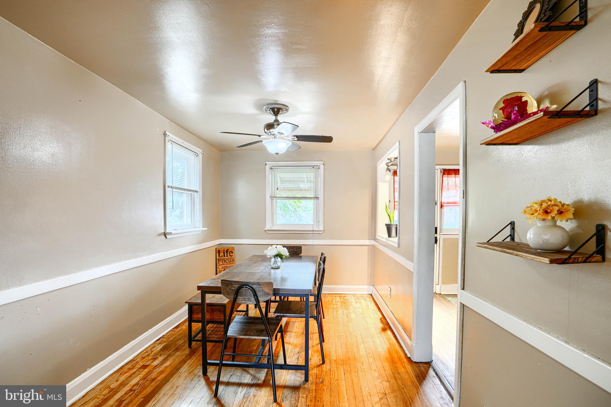 755 South Woodington Road Baltimore, MD 21229 - Photo 9 of 40 a view of a dining room with furniture and a chandelier