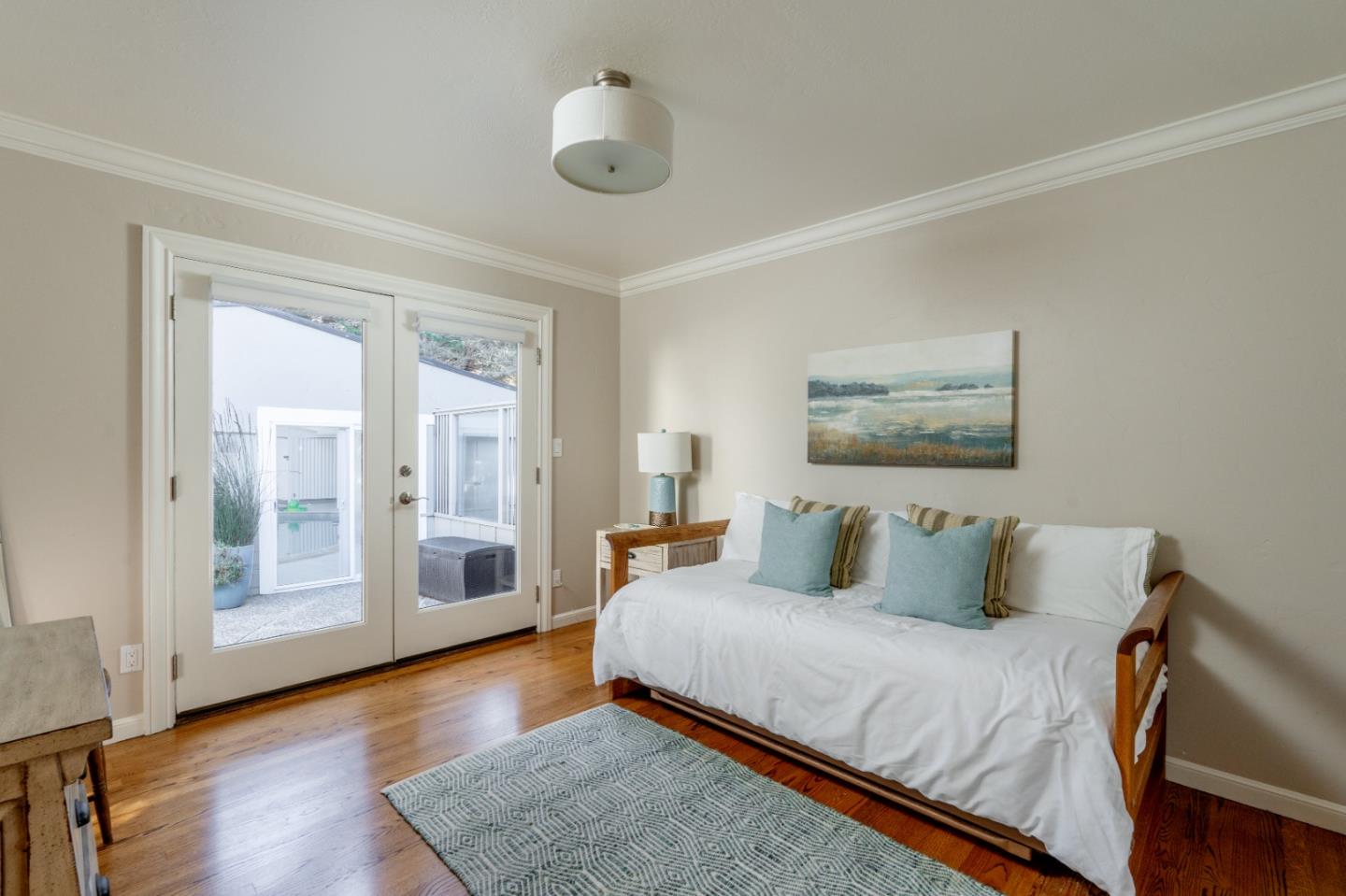 142 Carmel Riviera Drive Carmel, CA 93923 - Photo 14 of 23 a bedroom with a bed and wooden floor