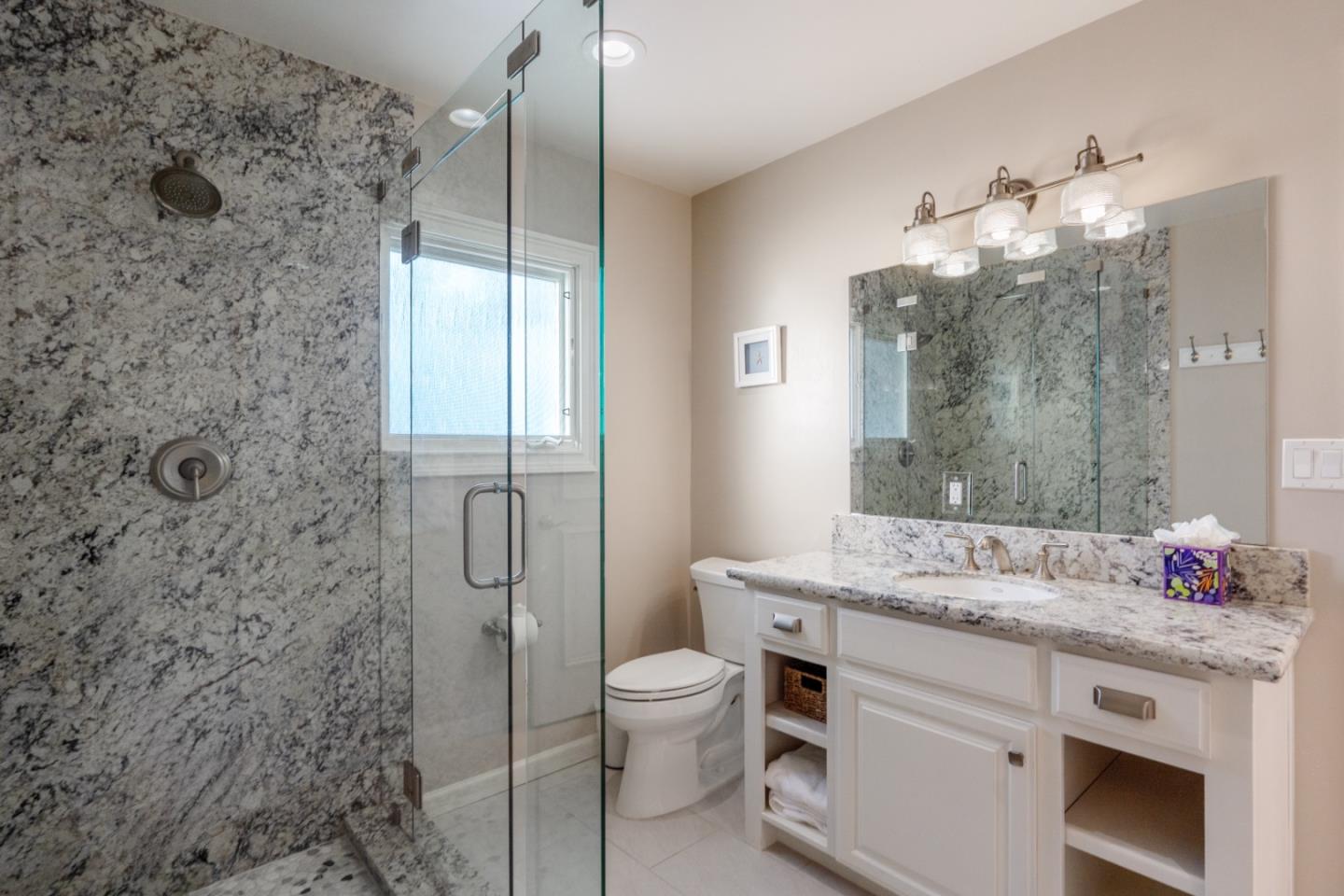 142 Carmel Riviera Drive Carmel, CA 93923 - Photo 15 of 23 a bathroom with a granite countertop sink toilet a mirror and shower
