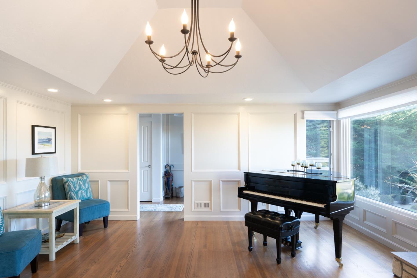 142 Carmel Riviera Drive Carmel, CA 93923 - Photo 3 of 23 a living room with furniture a table and wooden floor