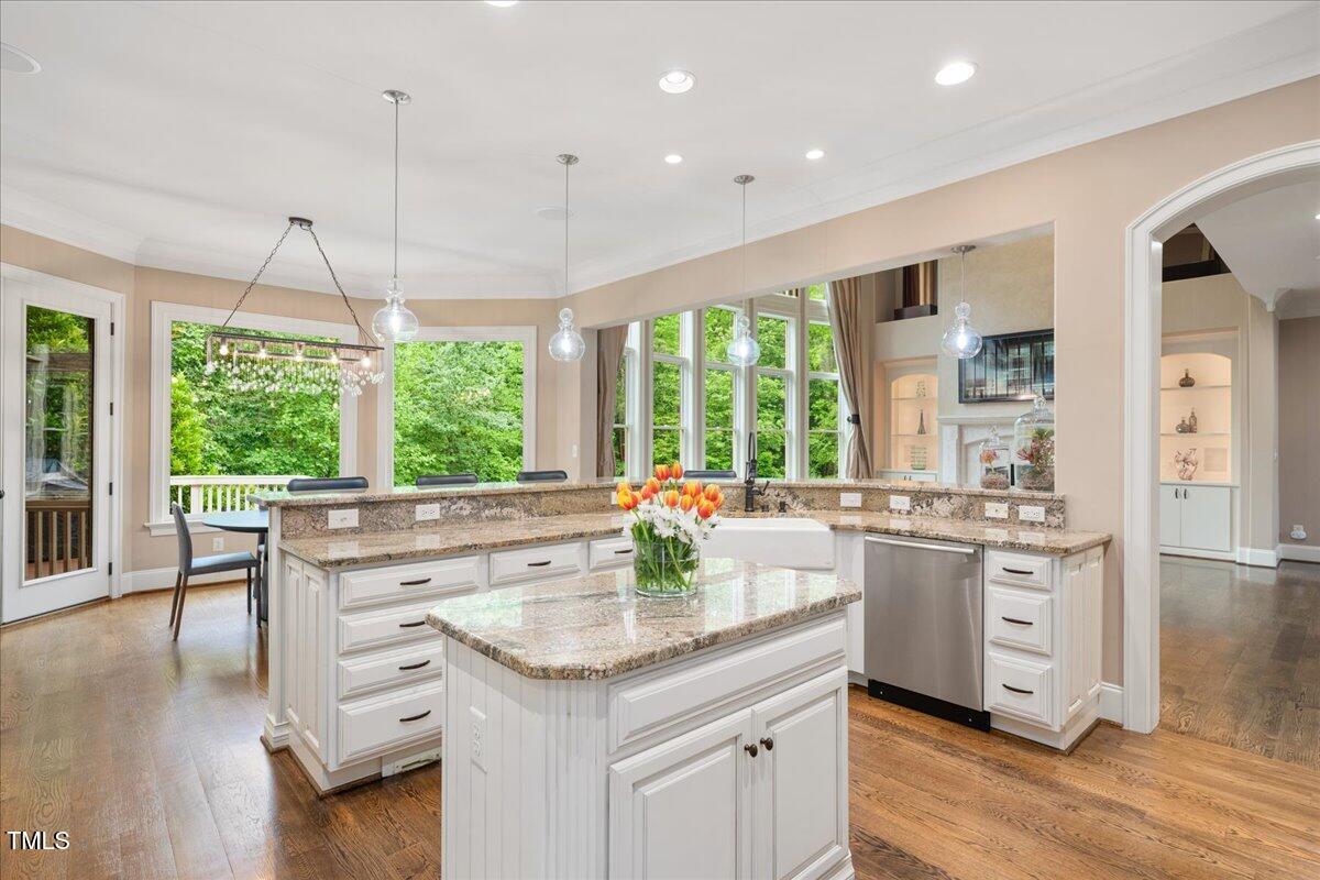 3601 Nightfall Court Raleigh, NC 27607 - Photo 15 of 88 a kitchen with stainless steel appliances granite countertop a stove and a wooden floors