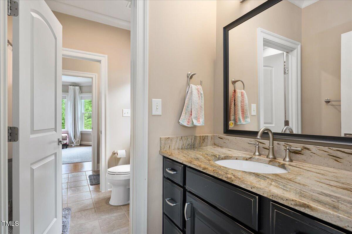 3601 Nightfall Court Raleigh, NC 27607 - Photo 31 of 88 a bathroom with a granite countertop sink and a mirror