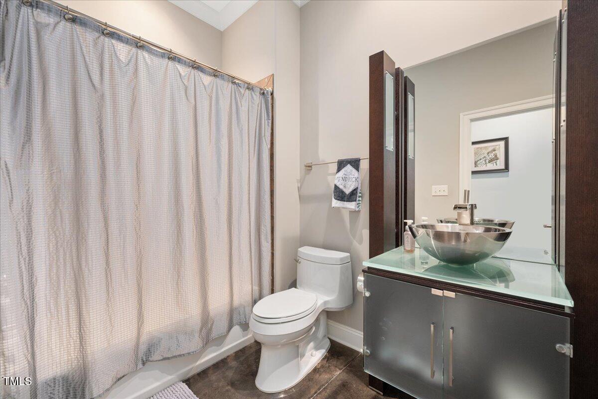 3601 Nightfall Court Raleigh, NC 27607 - Photo 45 of 88 a bathroom with a toilet a sink and mirror