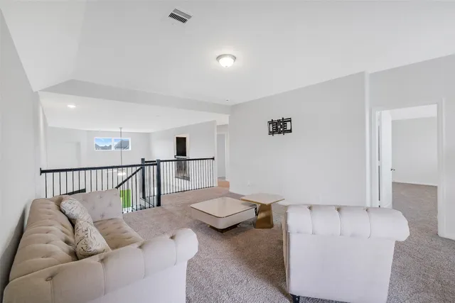 a large bed sitting in a bedroom next to a window